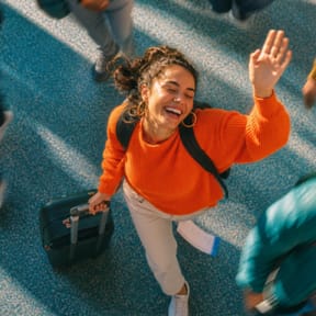 Traveler carrying a suitcase through a busy terminal