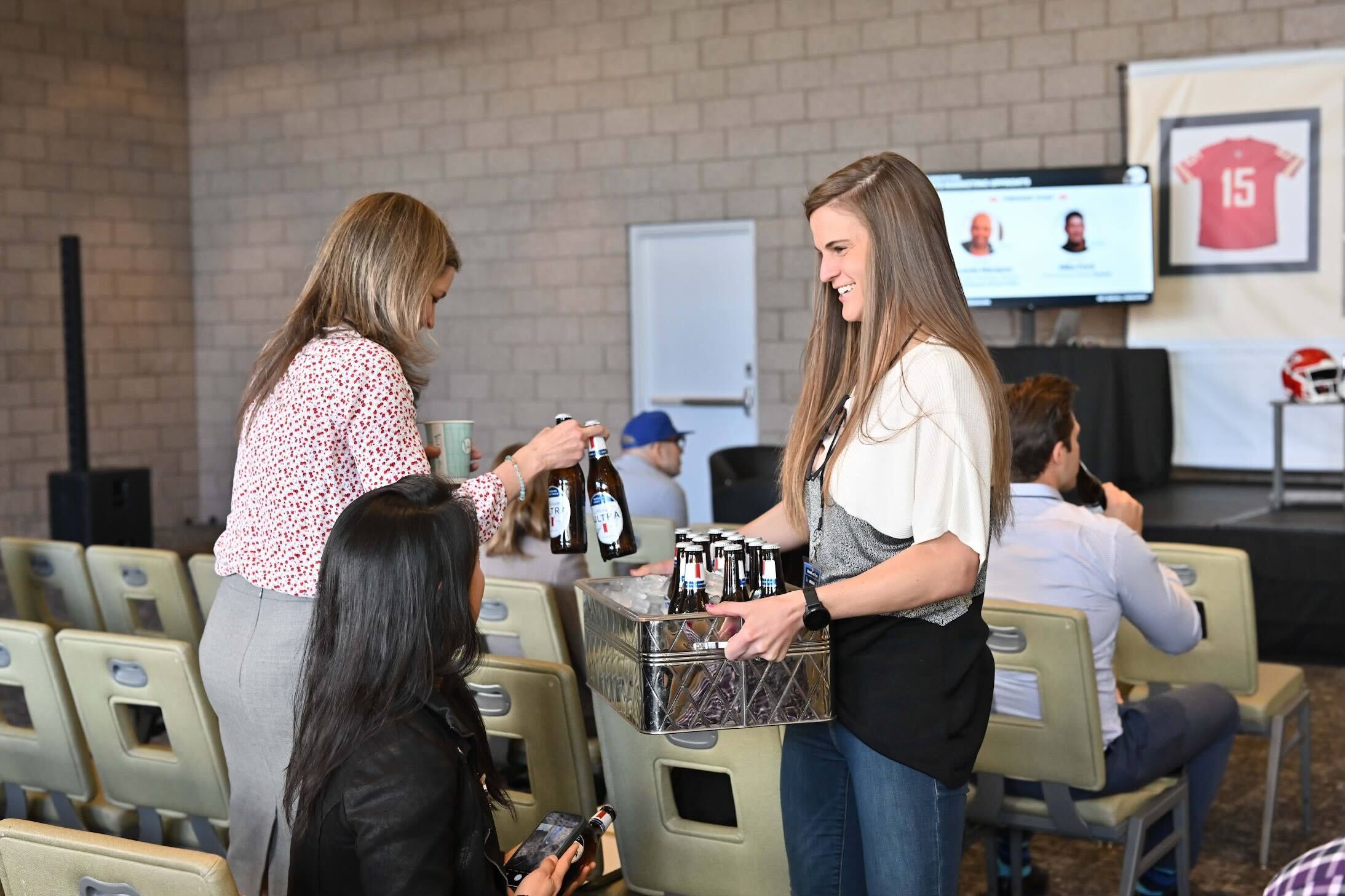 Photo of VP of Audience Intelligence, Ashley Spontelli passing out Michelob ULTRA beers. 